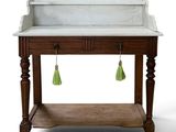 a white marble sink with green tassels hanging from it