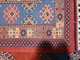 a blue and red rug with a pattern on it