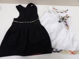 two dresses are sitting on a table next to each other