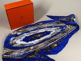 an orange box and a blue scarf on a white surface