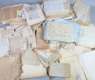 a pile of old papers sitting on top of a table