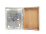 a small box with a small metal object inside of it
