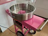 a cotton candy machine sitting on a pink cart in a kitchen
