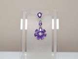 amethorate and diamond earrings in a clear display case