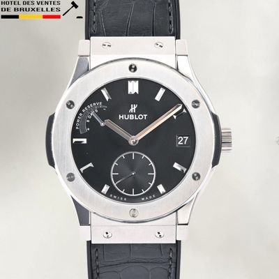 a close up of a watch with a black dial