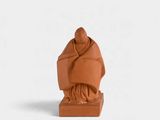 an image of a clay statue of a monk on a white background