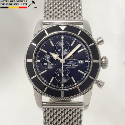 a close up of a watch with a blue dial