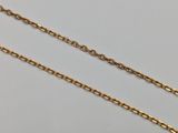 a pair of gold chain necklaces on a white background