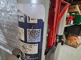 a fire extinguisor attached to the back of a fire hydrant