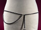 a mannequin torso with a chain belt attached to it