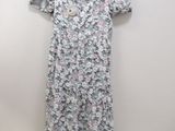 a dress hanging on a hanger against a wall