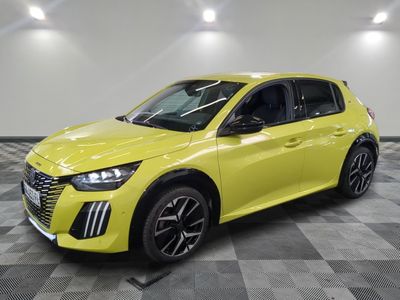 a yellow car is parked in a room with a checkered floor