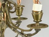 a chandelier that has a candle holder and a brush in it