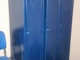 a blue locker next to a blue chair in a room