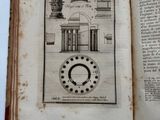 an open book with a drawing of a clock on it