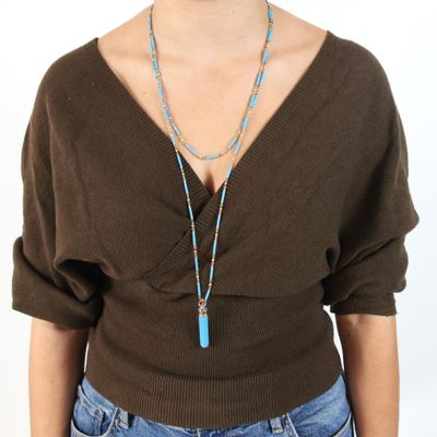 woman wearing a brown sweater and blue necklace with a turquoise pendant