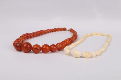 a pair of red and white jade beaded necklaces