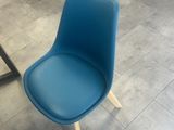 a blue chair that is sitting in a room