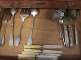a drawer full of silverware and knives and spoons