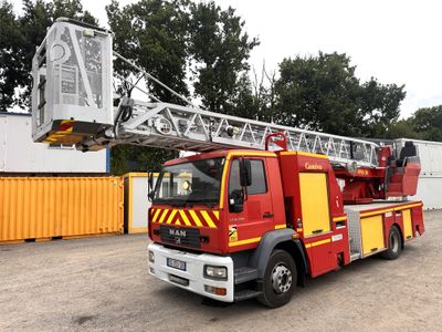 a red and yellow truck with a crane on it ' s back