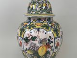 a vase with a lid that has a bird on it