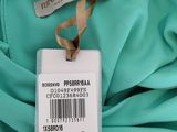 a close up of a label on a green shirt