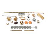 an assortment of gold and silver jewelry on a white background