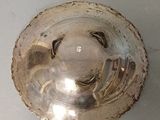 a silver object that is sitting on a white surface