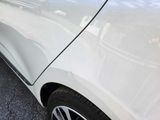 a white car parked on the side of the road