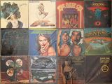 many different album covers on the wall of a room