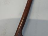a wooden axe that is laying on a white surface