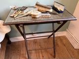 a small table with brushes and a comb on it