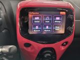 a red car dashboard with a digital display on it