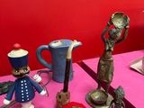 several figurines are on a pink table with a red wall