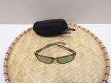 a pair of sunglasses sitting on top of a bamboo tray