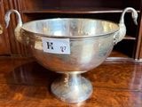 a silver bowl sitting on a wooden table
