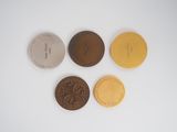 four different types of coins sitting on top of a white surface