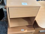 a stack of wooden drawers with a drawer underneath it