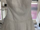 wedding dress hanging on a hanger in a bridal shop
