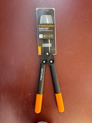 a pair of pliers sitting on a table next to a pair of shoes