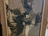 painting of a bird in a frame sitting on a table