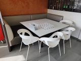 a white table and chairs in a corner of a restaurant