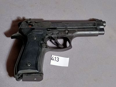 a gun on the table with a price tag on it