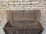 a wooden chest with a carved design on it