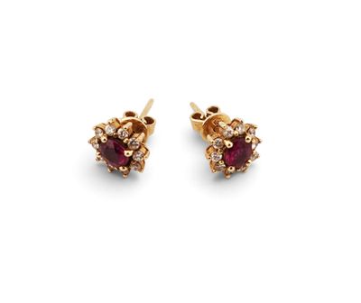 a pair of ruby and diamond earrings on a white background