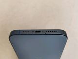 the back of a blue iphone with a small hole in the middle of it