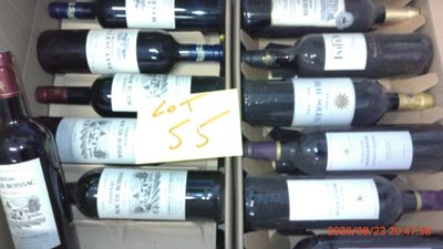 many bottles of wine in a box with a price tag on it