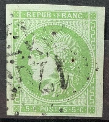 un timbre vert sur lequel figure le visage d'une femme
