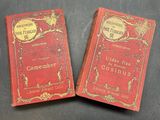 two red books sitting on top of a table next to each other