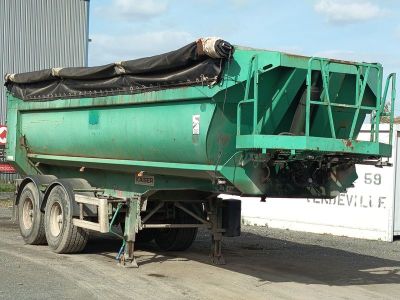 a green dump truck that is parked on the side of the road